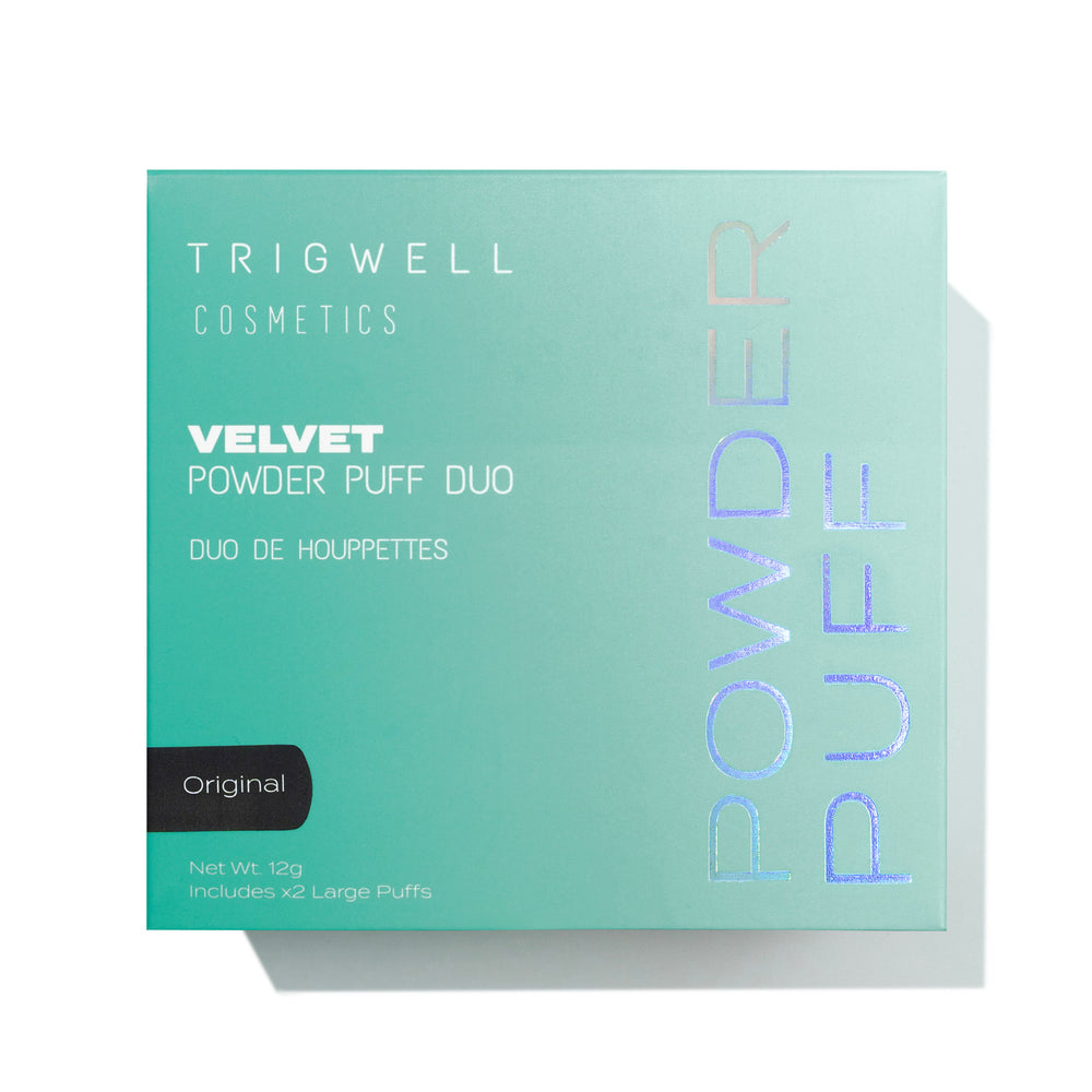 large powder puff with brand name 'Trigwell Cosmetics' printed in white text on the black ribbon of the powder puff 