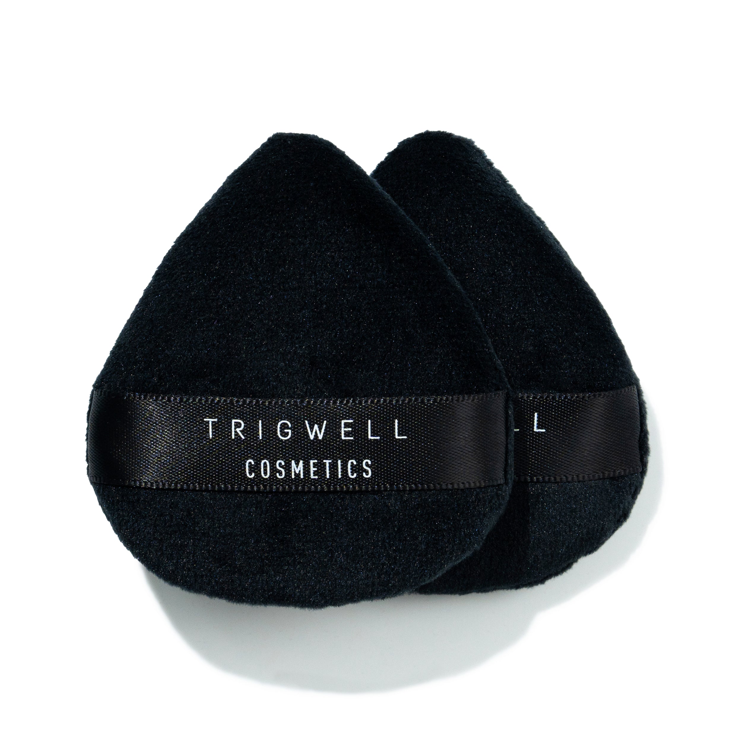 two mini powder puffs with brand name 'Trigwell Cosmetics' printed in white text on the black ribbon of the powder puff 