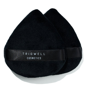 large powder puff with brand name 'Trigwell Cosmetics' printed in white text on the black ribbon of the powder puff 