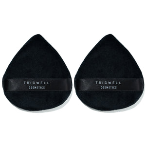 large powder puffs with brand name 'Trigwell Cosmetics' printed in white text on the black ribbon of the powder puff 